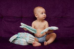 Baby holding diapers