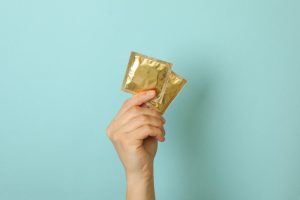 female holding condoms